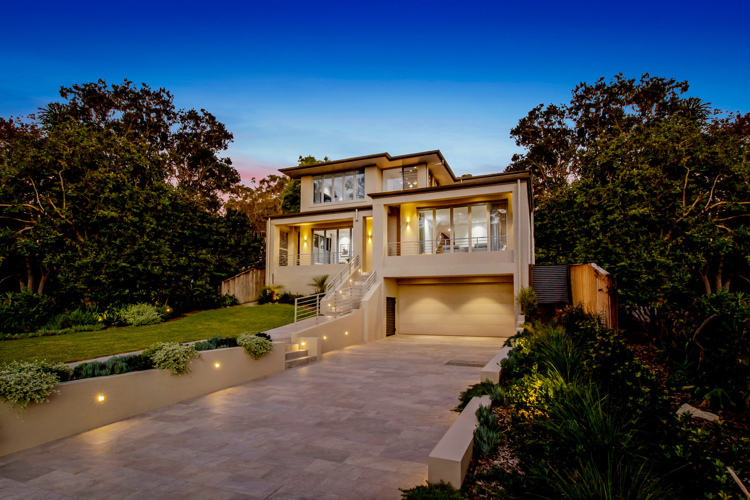 Modern home entrance at dusk on a slope