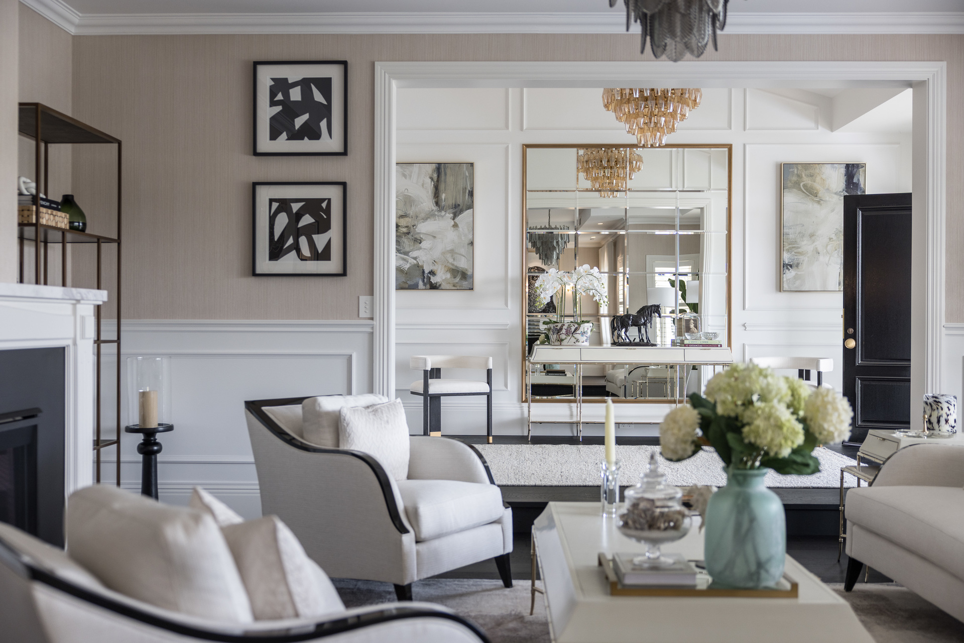 Cream lounge area with charcoal accents and luxurious textures, looking to the entry.