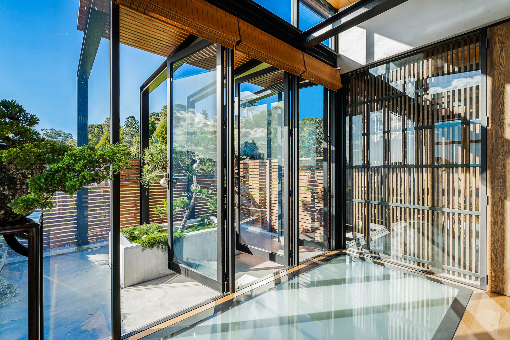 Open floor to ceiling glass doors onto balcony