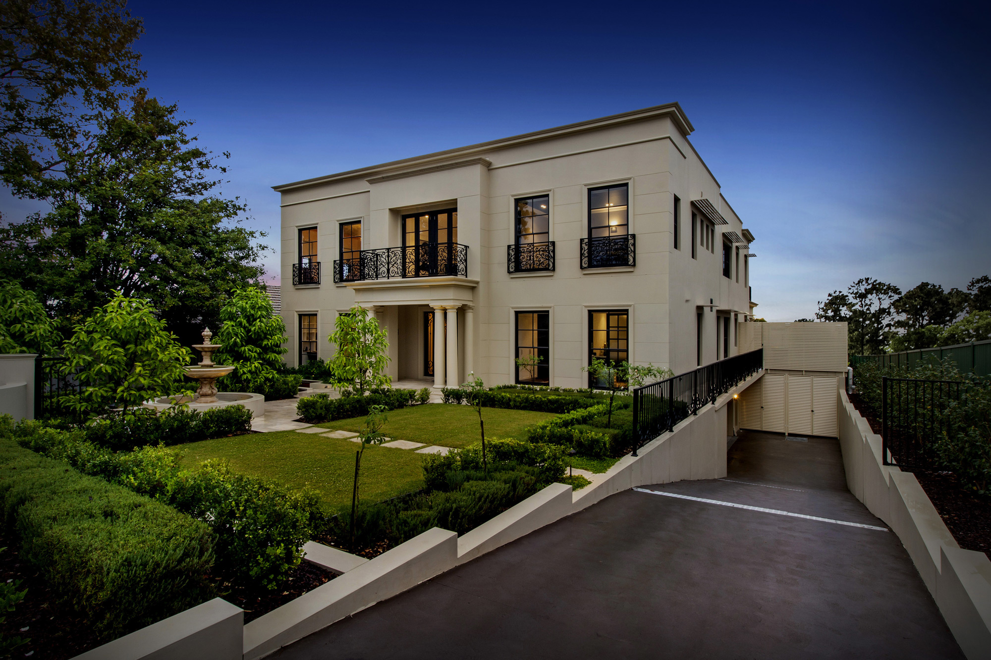 Oatlands Neo-Classical: front facade with a driveway sloping to side under the house