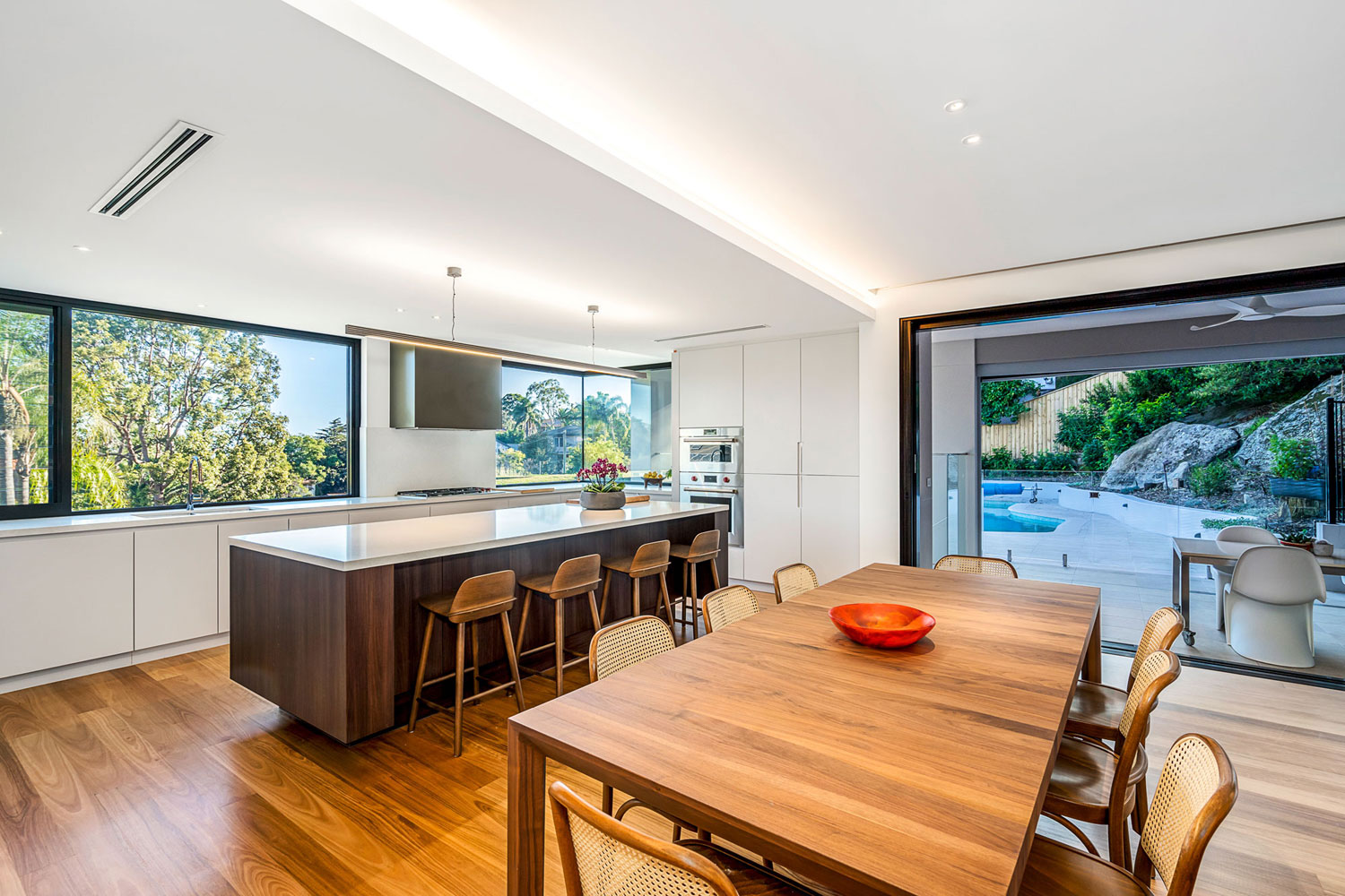 Northbridge Modern: dining and kitchen flow uninterrupted into outdoor living