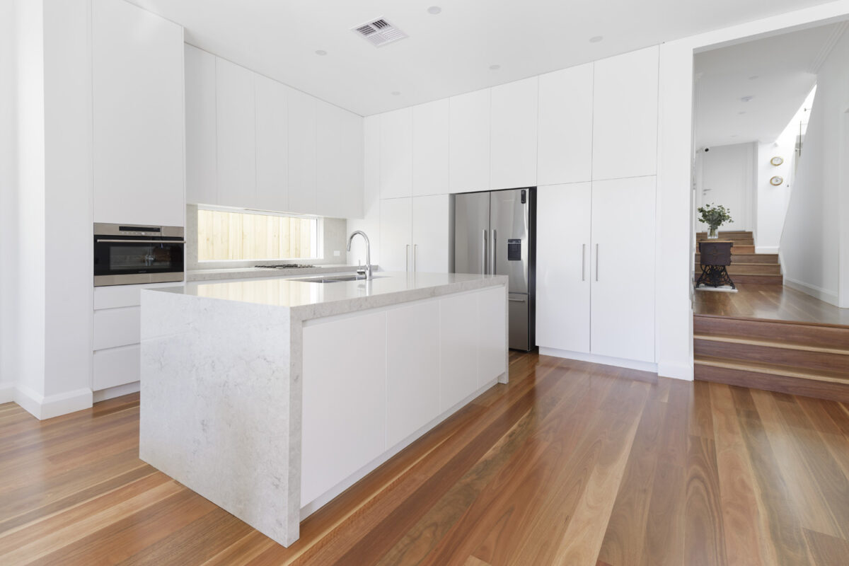 North Bondi Contemporary: white kitchen with warm timber flooring