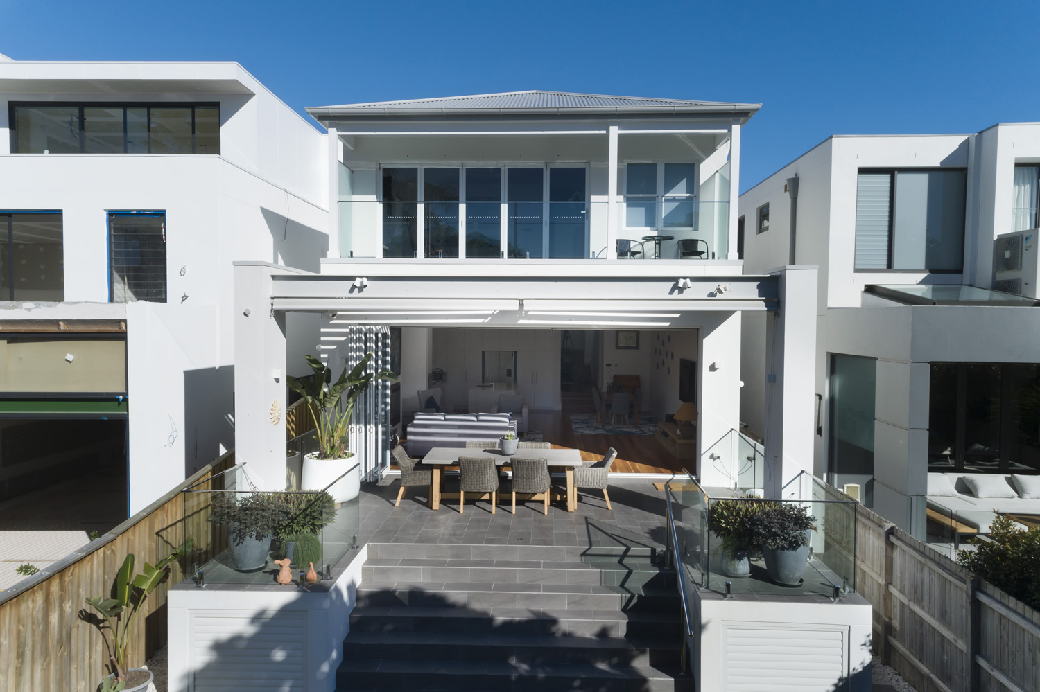 North Bondi Contemporary: 2 storey home from the backyard – maximising space with neighbours to the left and right