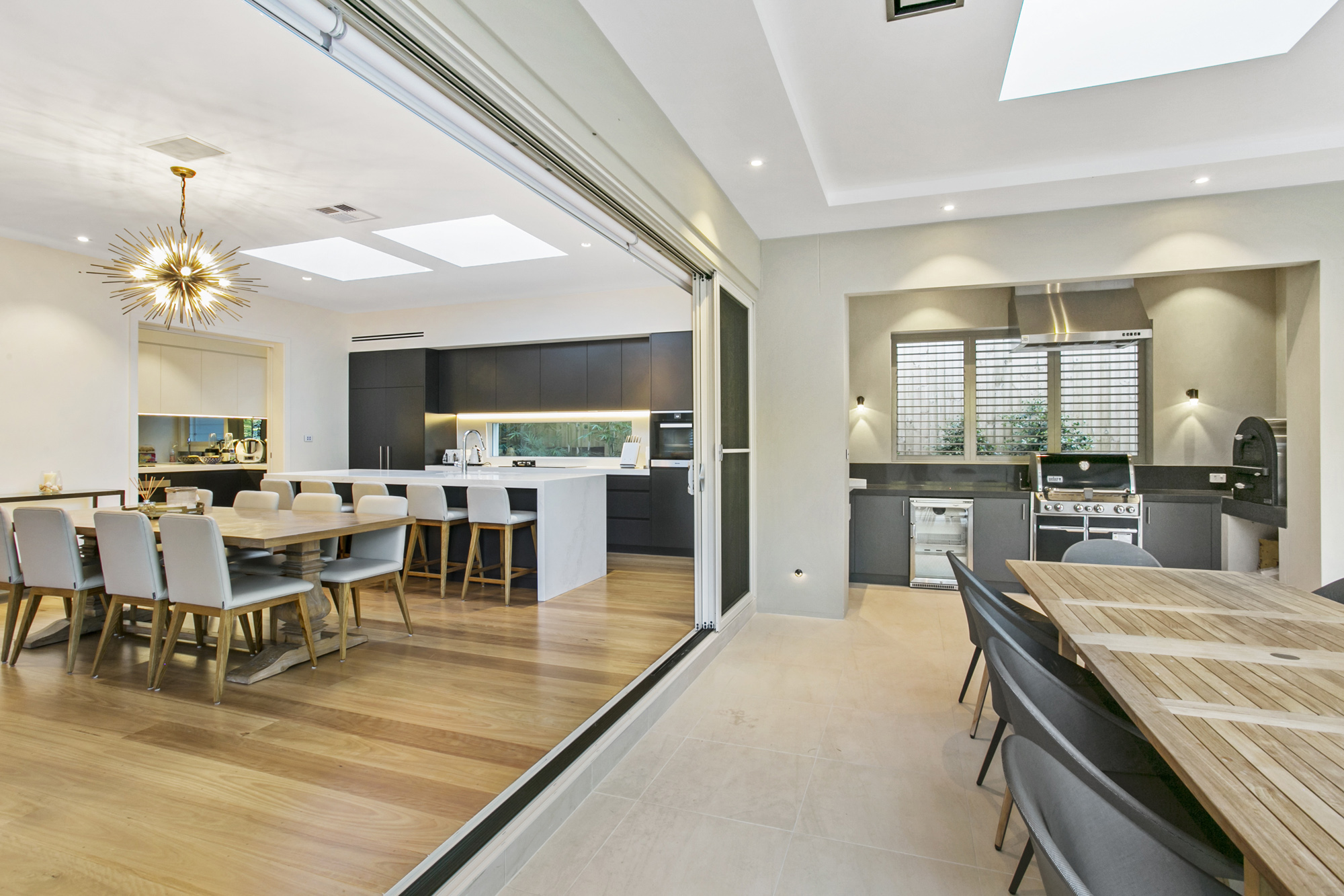 North Wahroonga: indoor kitchen and dining seamlessly flow onto outdoor kitchen and living