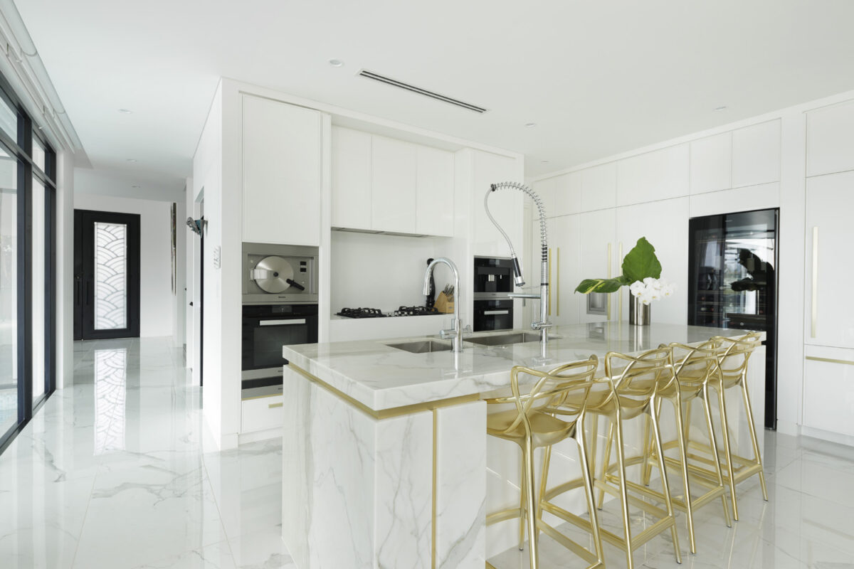 Rodd Point Contemporary: marble kitchen with gold bar stools